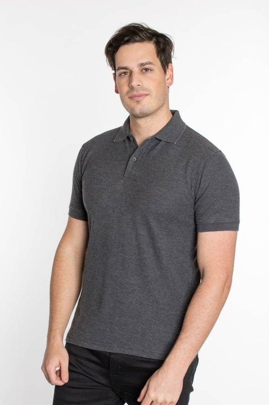 A man wearing a gray polo shirt with short sleeves, standing against a plain background.