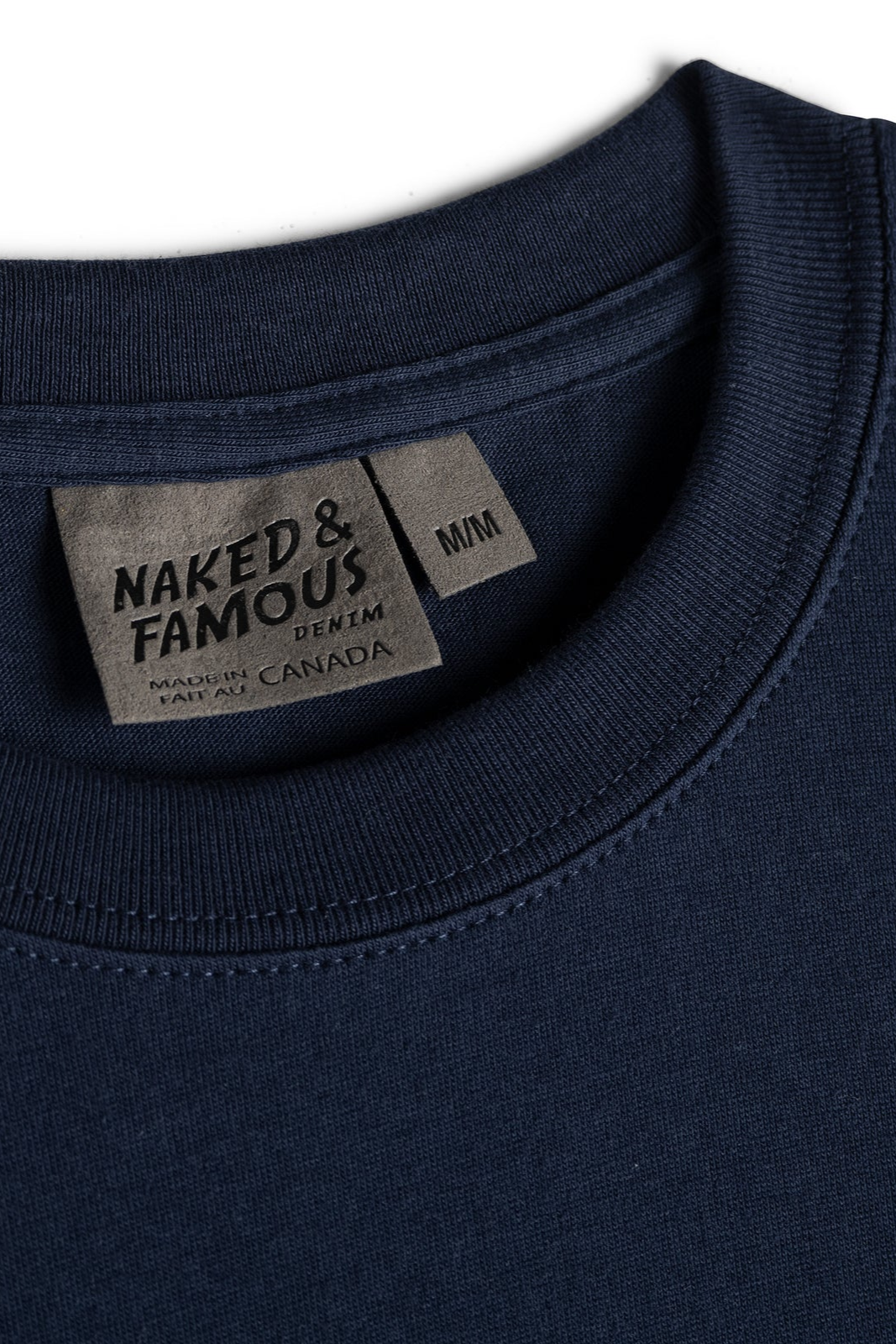 Naked & Famous denim label on a navy blue garment
