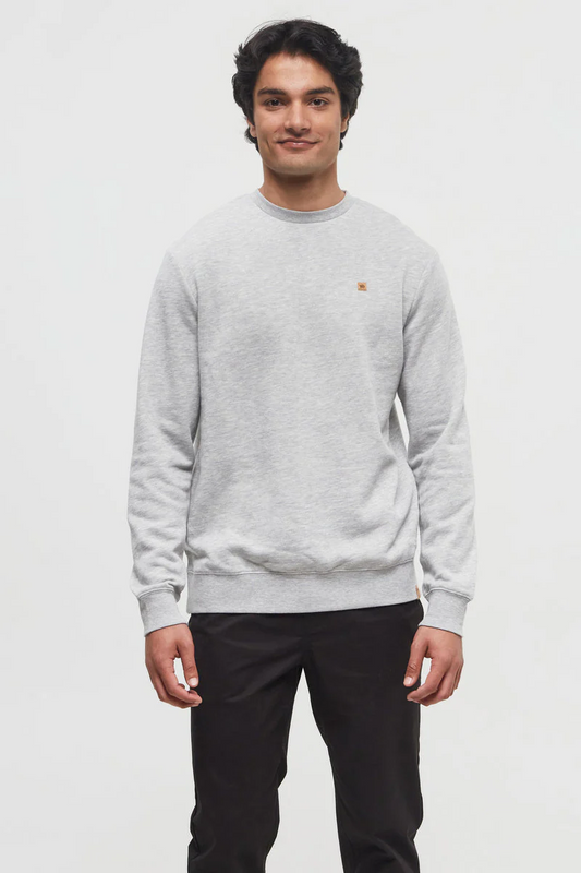 Man wearing a gray sweater with a small logo on a white background