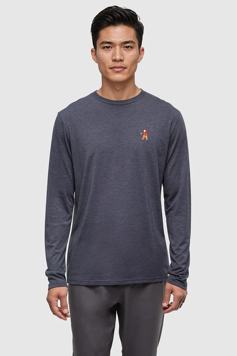 Man wearing a dark gray long-sleeve shirt with a small red logo on a light gray background