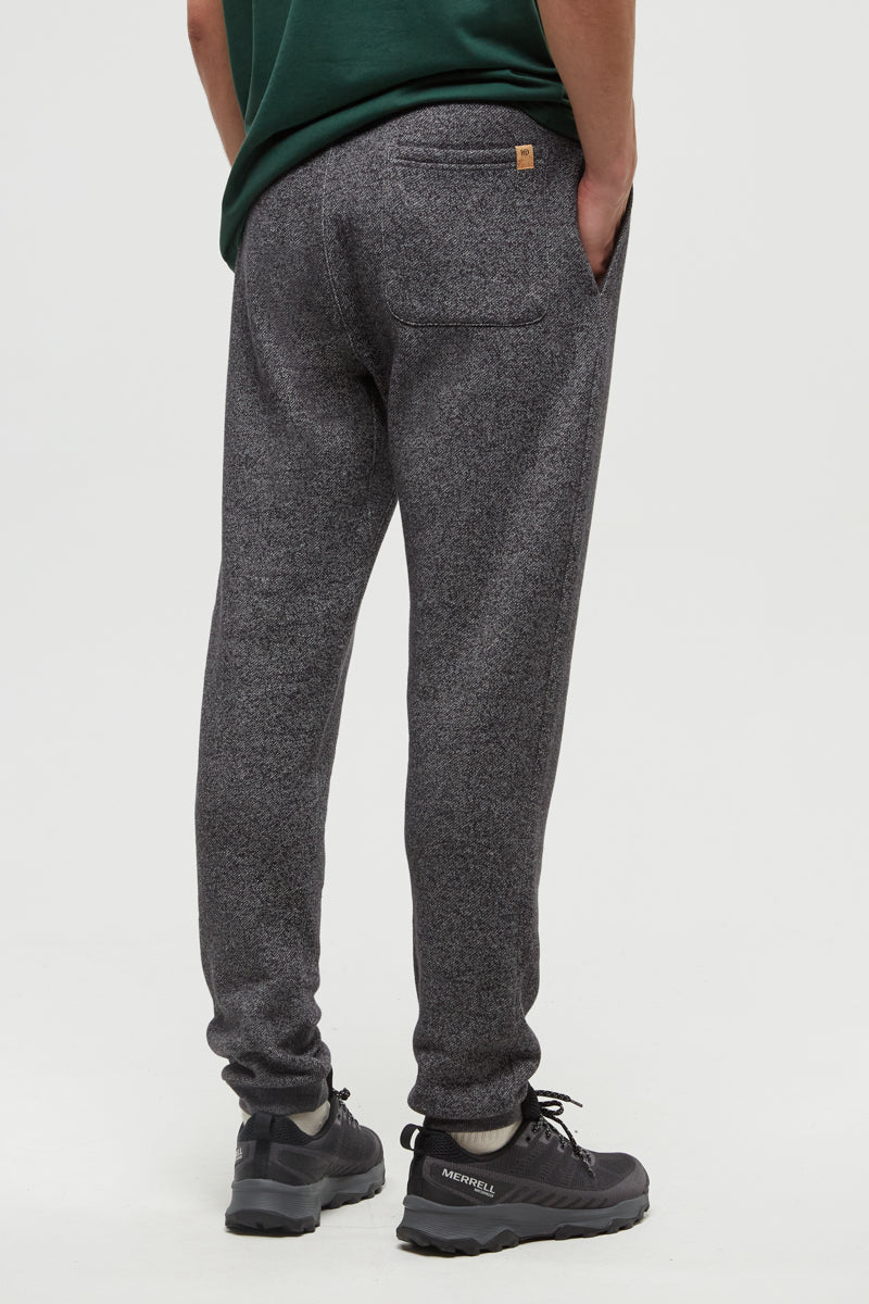 Person wearing gray sweatpants on a white background
