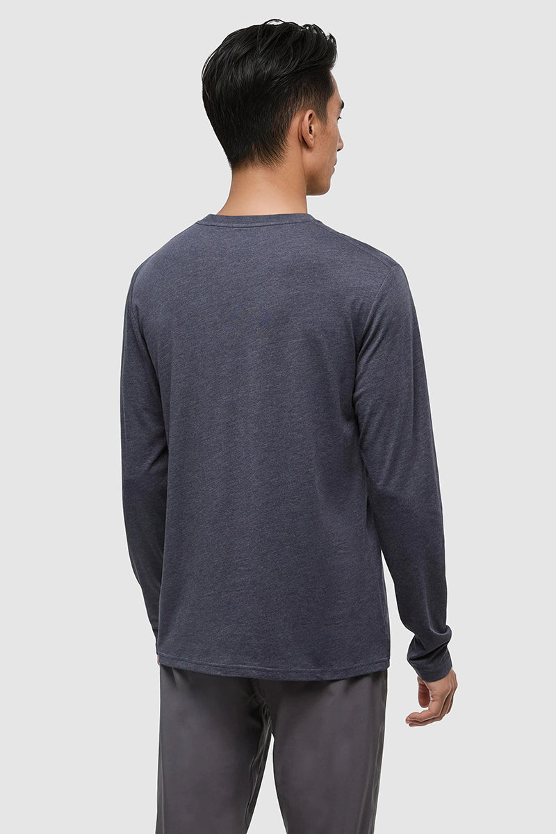 Person wearing a dark gray long-sleeve shirt and pants on a white background