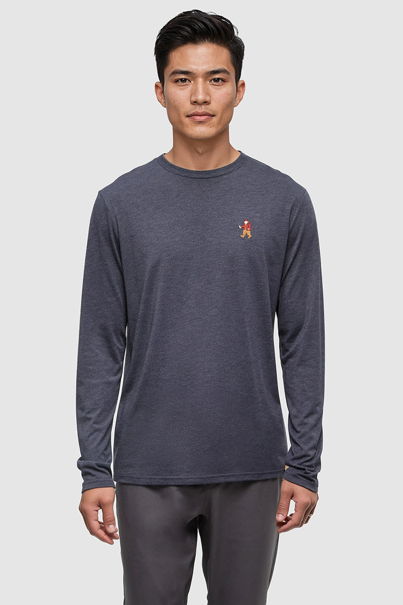 Man wearing a dark gray long-sleeve shirt with a small red logo on a light gray background