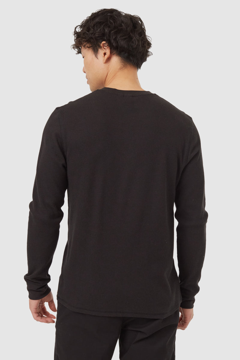 Person wearing a black long-sleeve shirt on a white background