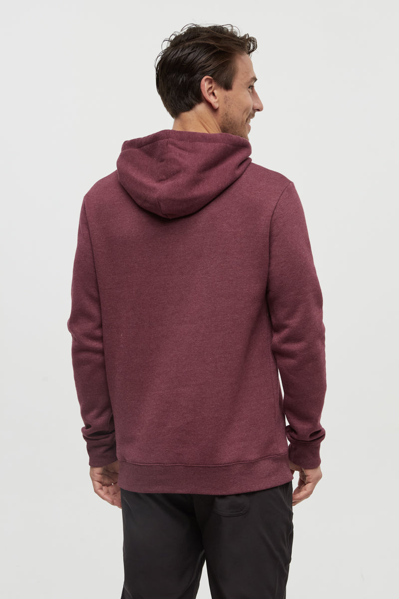 Man wearing a maroon hoodie on a light gray background