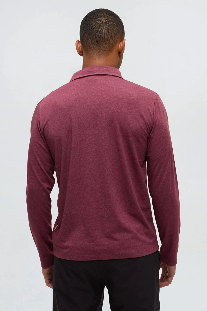 Person wearing a maroon long-sleeve shirt on a white background