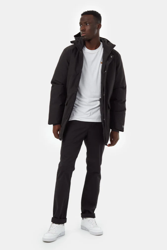 Man wearing a black jacket, white shirt, black pants, and white sneakers on a white background