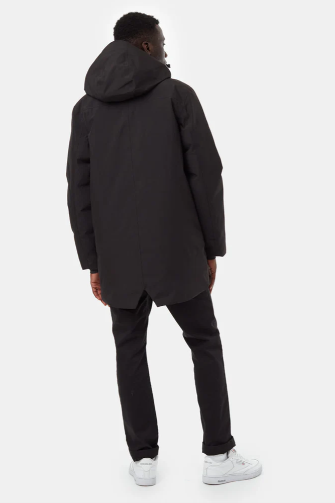 Person wearing a black coat and pants on a white background
