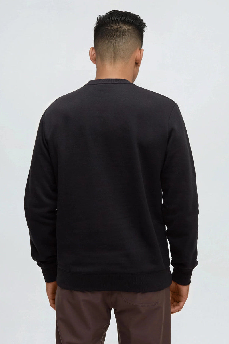 Person wearing a black sweatshirt against a white background