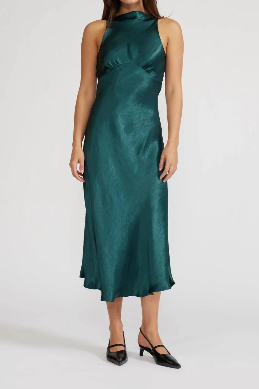 Woman wearing a green satin dress on a white background