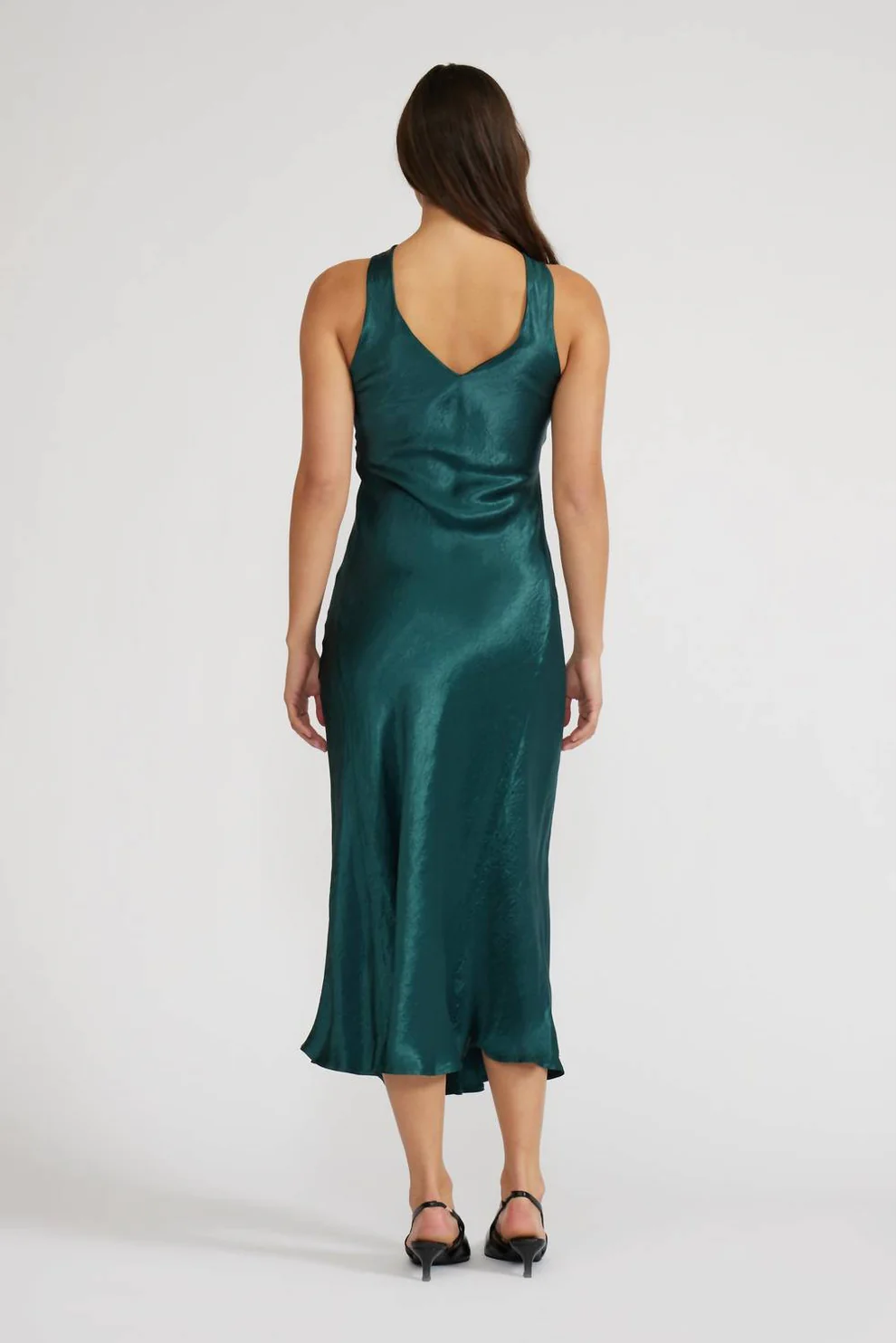 Woman wearing a green satin dress on a white background