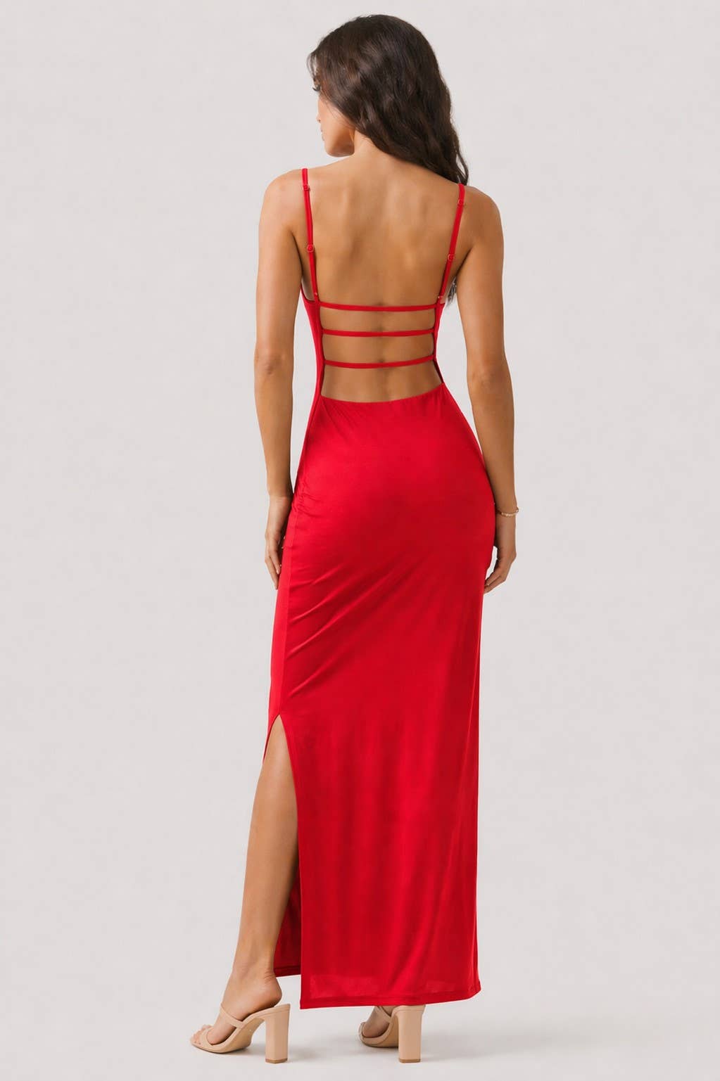 Red evening gown with cut-out back on a white background